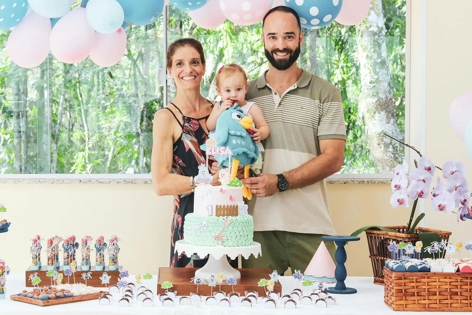 A family posing for the camera with a cake.